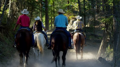 Horses running in Roundup on Dude Ranch with Cowboy Riders