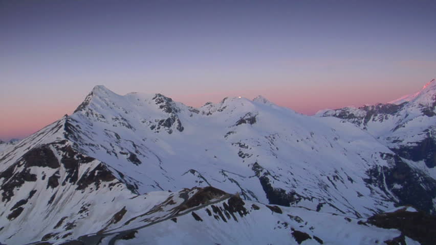 Pink and Orange Sunrise Over The Snow Covered Alps