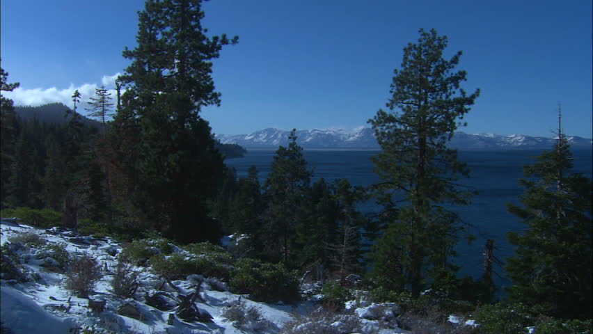 Blue Lake Tahoe In Winter With Mountains and Forest