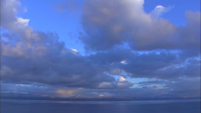 Dark Clouds Against Blue Sky Moving Over Lake Tahoe And Surrounding Mountains,