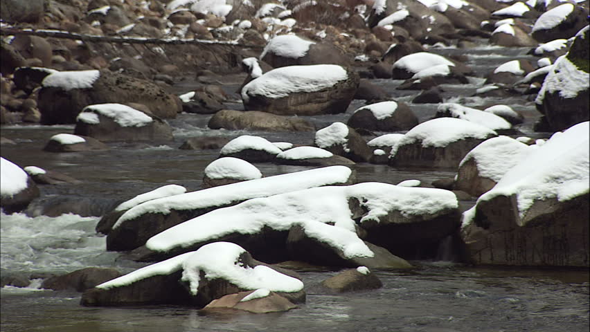 Snow Capped Rocks In Crisp River