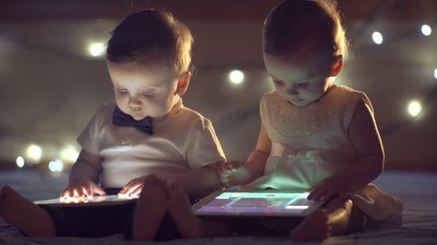 Two children playing with a tablet วิดีโอสต็อก
