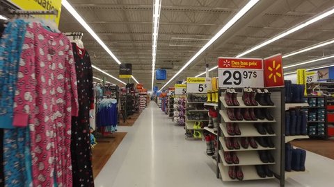 MONTREAL, CANADA - FEBRUARY 2016: Walking through Walmart store - Clothing & accessories area to food