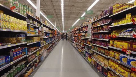 MONTREAL, CANADA - FEBRUARY 2016: Walking through Walmart store - Sauces, oils, pasta, rice, food cans etc.