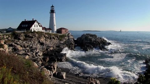 The Portland Head Lighthouse oversees the ocean from rocks in Maine, New England. 