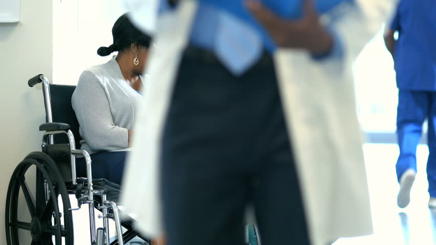 Medical consultation with African American female staff and disabled patient Royalty-Free Stock Footage #14722324