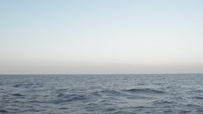 ship on horizon in open sea. video taken from sailing ship.