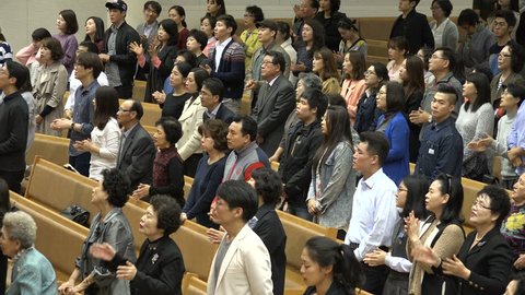SEOUL, SOUTH KOREA - 11 OCTOBER 2015: People attending a church mass sing Halleluja in Seoul, South Korea
