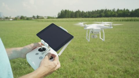 Ljubljana, Slovenia, July 25, 2015, CLOSE UP: Flying small white Phantom drone with transmitter