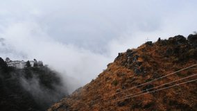 Locked-On shot of fog over mountains, Mussoorie, Uttarakhand, India