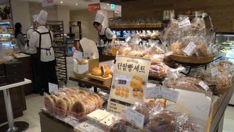 SEOUL, SOUTH KOREA - 9 OCTOBER 2015: Bakery shop offering various breads and pastries, employees with tall white hats at work, popular shopping mall in Seoul, South Korea
