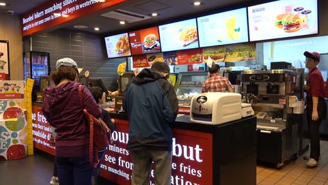SEOUL, SOUTH KOREA - 9 OCTOBER 2015: People order hamburgers, fries and drinks at a popular Lotteria cafetaria, a Korean version of the classic Western fast food restaurant, in Seoul, South Korea