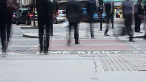 Time lapse video of a busy crossroad in the heart of the City of London's financial district showing pedestrians and road traffic including London buses, London Taxi's and cyclists.