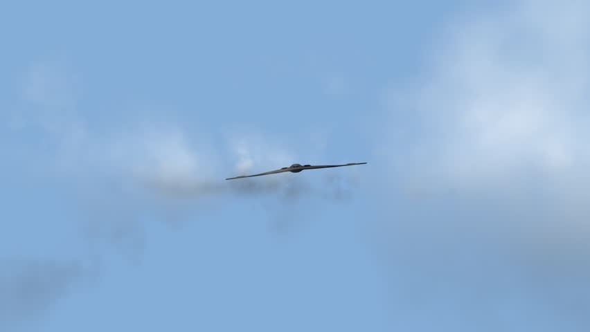 B2 Bomber flying up close and veering off to the right.