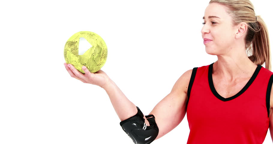 Smiling sportswoman plays handball on white background