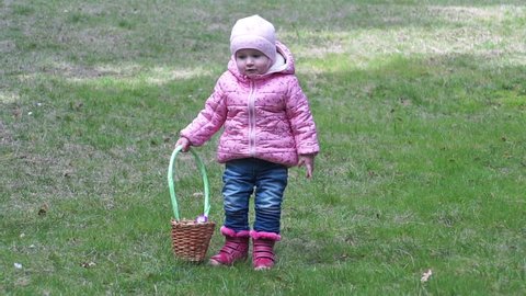 Little girl collecting Easter eggs