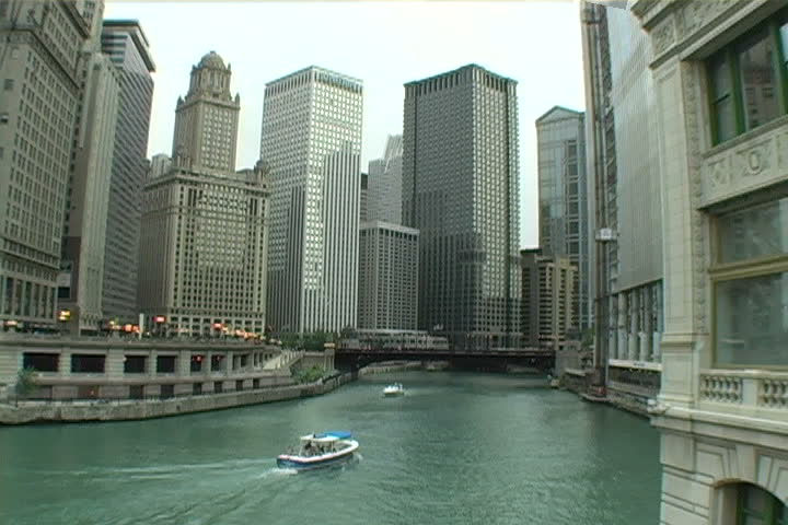Two boats passing each other on the Chicago river.
