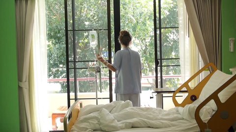 Stressful Upset Young Woman in Hospital at Window