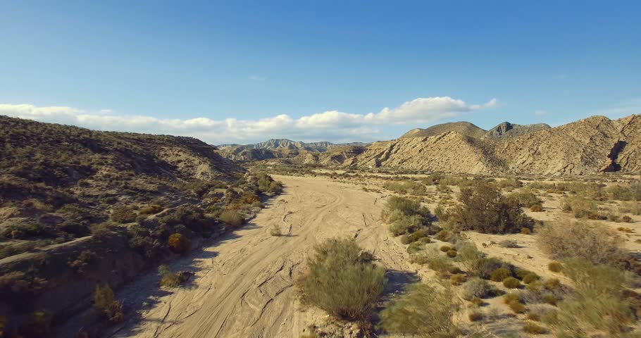 4K Aerial, Flight over a dry riverbed in a desert in Andalusia, Spain - Shot is additionally stabilized, graded and mostly accelerated. Watch also for the native versions Royalty-Free Stock Footage #14786389