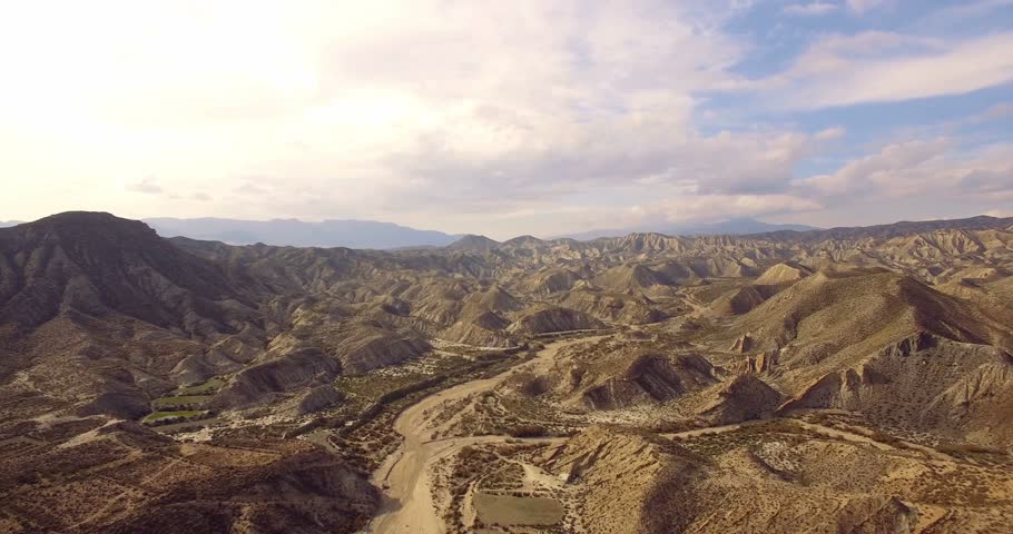4K Aerial, Flight over a dry riverbed in a desert in Andalusia, Spain - Shot is additionally stabilized, graded and mostly accelerated. Watch also for the native versions Royalty-Free Stock Footage #14786413
