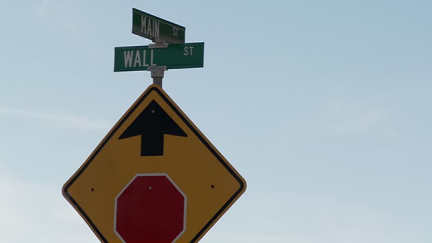 A street sign indicates the intersection of Main and Wall Streets.
