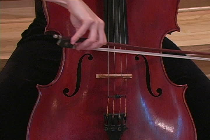 A young woman playing the cello.