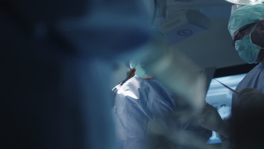 Medical Team Performing Surgical Operation in Modern Operating Room. Shot on RED Cinema Camera. Royalty-Free Stock Footage #14791465