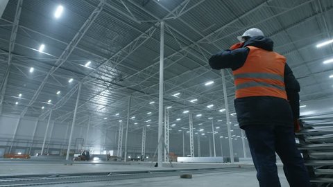 engineer talking on the phone in new modern industry warehouse