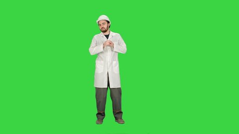 Funny dancing construction worker, architect, Electrician in helmet on a Green Screen, Chroma Key.