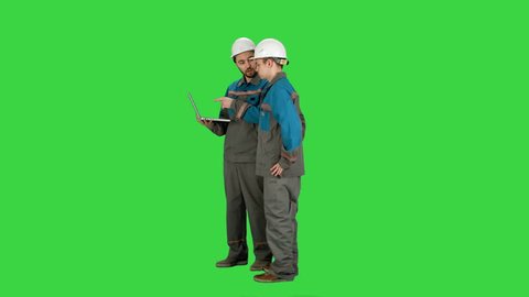 Supervisors using laptop at construction site on a Green Screen, Chroma Key.