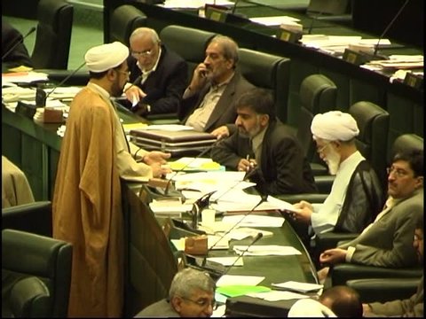 Parliament, Tehran, Iran - 2005 - An MP who is a Muslim cleric is standing and talking to his colleague in the Iranian Parliament.