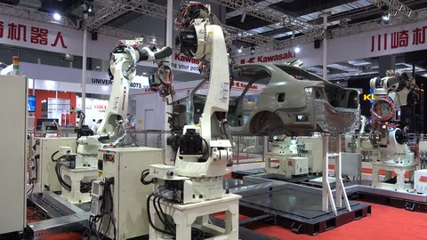 SHANGHAI, CHINA - 7 NOVEMBER 2015: Assembly line for cars, robotic arms, automated production process, trade show in Shanghai, China
