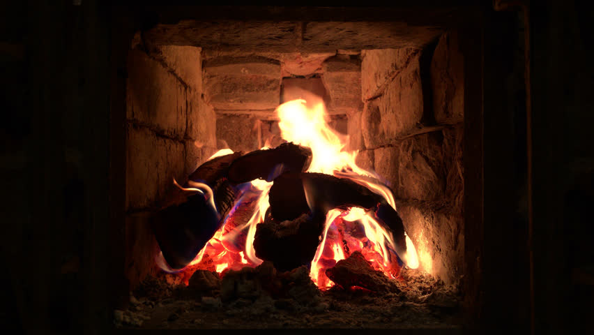 Wooden fire beams burning in Russian furnace at evening, fire sparks rise up with yellow spurts of flame. Steady close up shot. Seamlessly looped animation. | Shutterstock HD Video #14820454