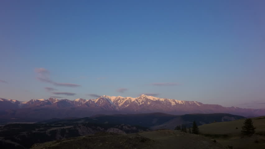 Clouds float over the North Chuya ridge at dawn. TimeLapse