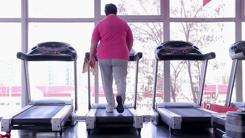 Overweight woman doing exercises, fat senior lady working hard to lose weight