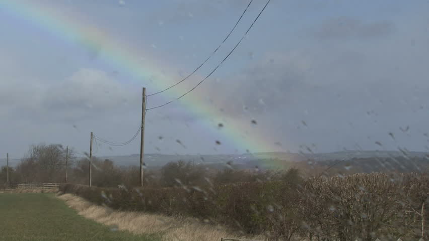 In focus rainbow, out of focus raindrops on window. HD.