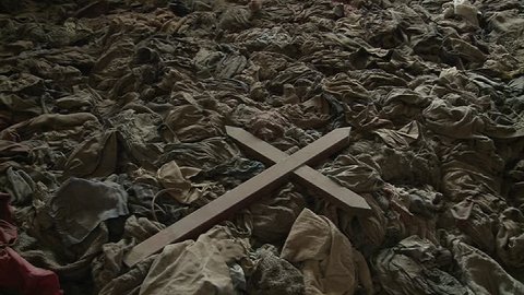 A cross sits amongst the scattered clothing of victims following a genocide in a church in Rwanda.