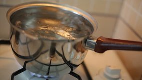Close up of boiling water in a pan. Soft focus.