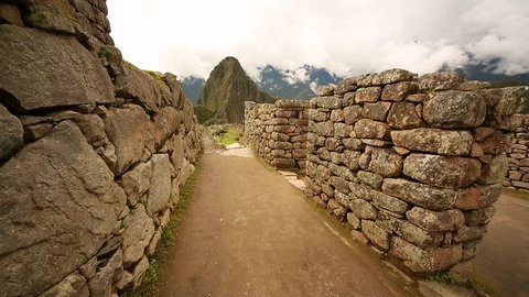 Walking in the buildings of Machu Picchu to the classical view of Machu Picchu with Wayna Picchu. Ideal for a time lapse video.