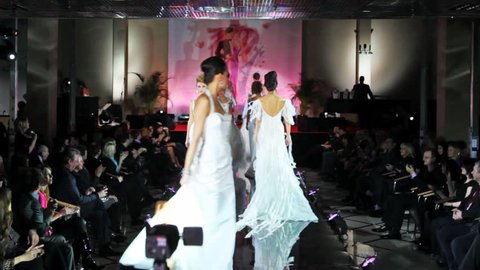 MOSCOW - FEBRUARY 14: Models in white wedding dresses walk catwalk at Evening of French fashion in salon Estet, on February 14, 2011 in Moscow, Russia.  Editorial Stock Video