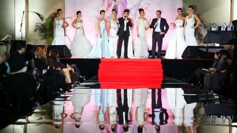 MOSCOW - FEBRUARY 14: Models in white wedding dresses stand on stage in front of catwalk at Evening of French fashion in salon Estet, on February 14, 2011 in Moscow, Russia. Editorial Stock Video