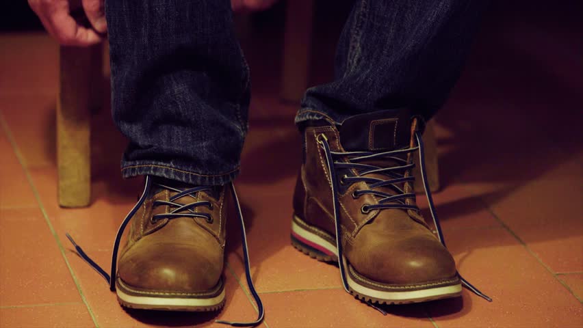 Close up of a man tying his boots. 