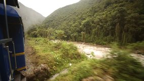 video footage of a driving train from Cusco to the Inca City Machu Picchu in a nice landscape with the river Urubamba