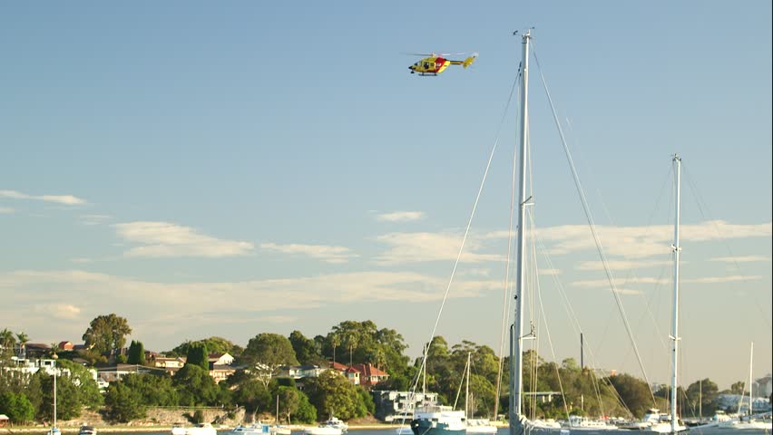 Rescue Helicopter Flying Over a Harbour