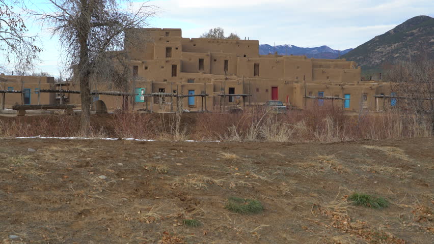 Footage with tilt up motion of traditional Native American houses in Taos Pueblo, New Mexico