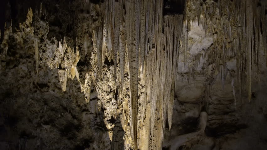 Tracking shot with tilt down motion of stalactites in Carlsbad Caverns National Park in New Mexico