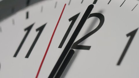 4K Slow zoom in to a clock face as the clock strikes midnight, or midday