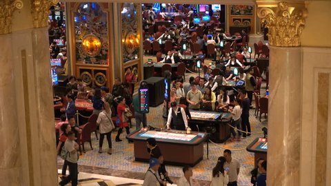 MACAU - 24 OCTOBER 2015: Mainland Chinese visitors gamble inside the Venetian Macao, one of the largest and most popular casino and hotel resorts in the world