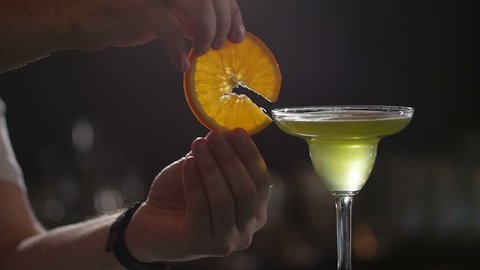 The bartender at the restaurant prepares a cocktail . Slow motion.