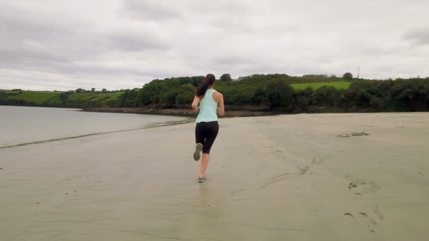 Fit woman running on the sand